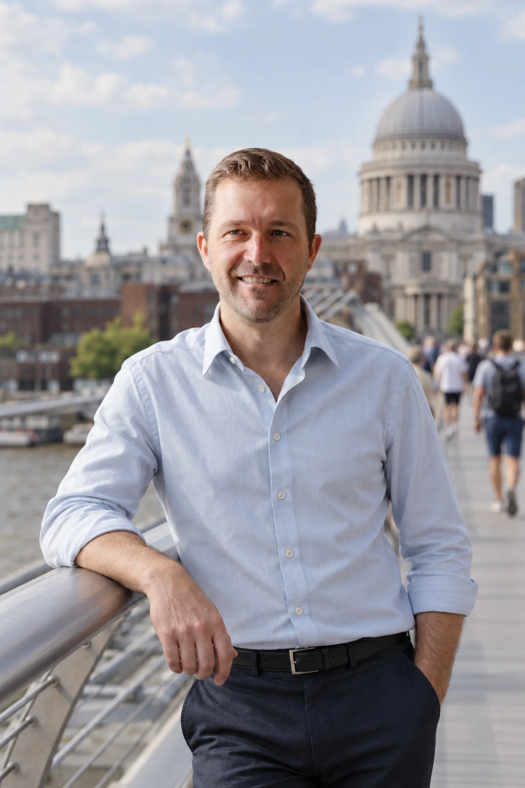 Nat Baldwin on the Millennium Bridge in London on a summer evening, St Paul's Cathedral behind him